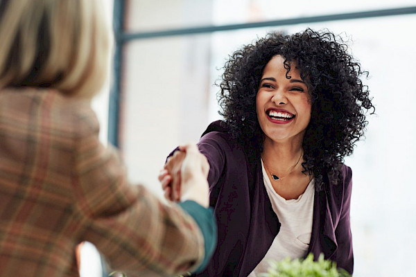 New home care franchise owner shaking hands during franchise agreement