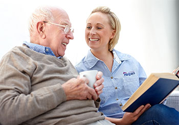 Senior Helpers franchise caregiver providing home care to an elderly client